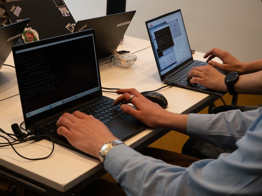 Hands typing on PC keyboards